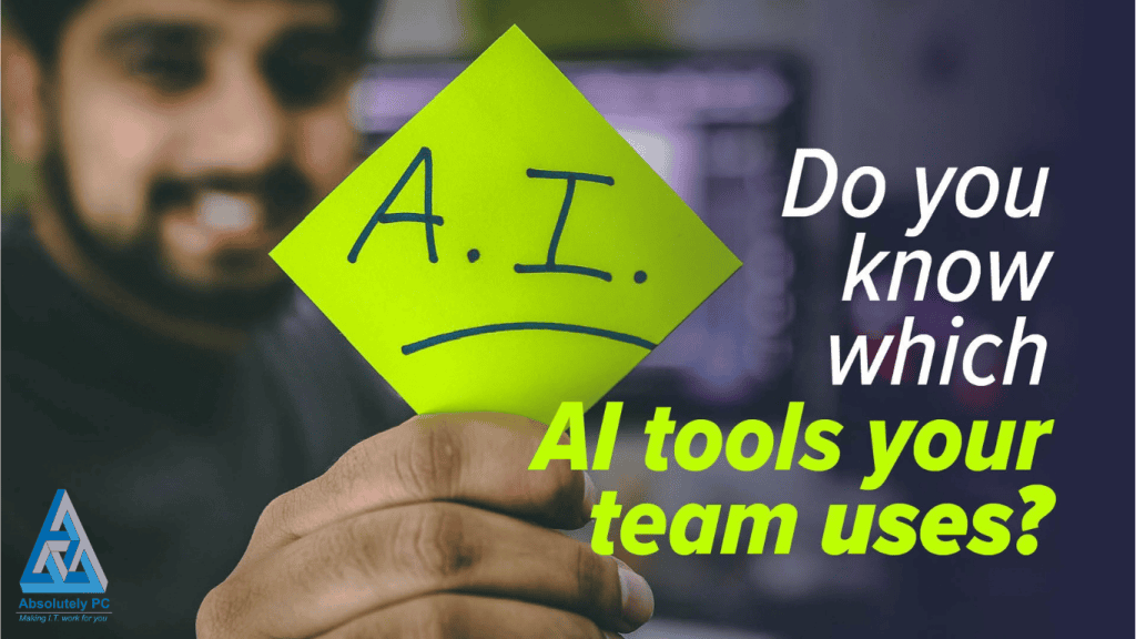 A smiling man holding up a bright yellow sticky note marked "A.I." with a downturned mouth drawn beneath the letters, beside the headline "Do you know which AI tools your team uses?" and the Absolutely PC logo.
